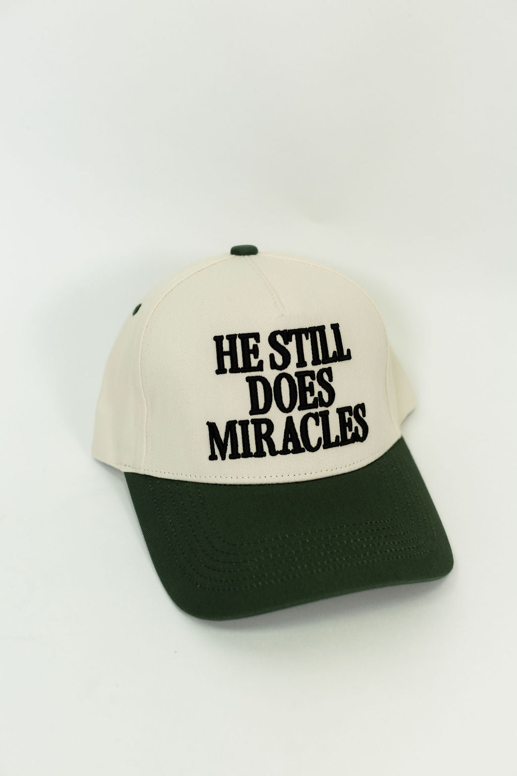 He Still Does Miracles Trucker Hat