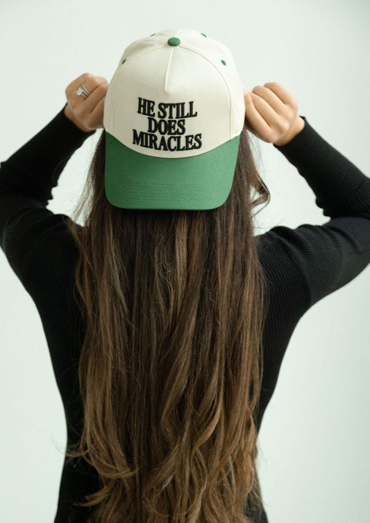 He Still Does Miracles Trucker Hat